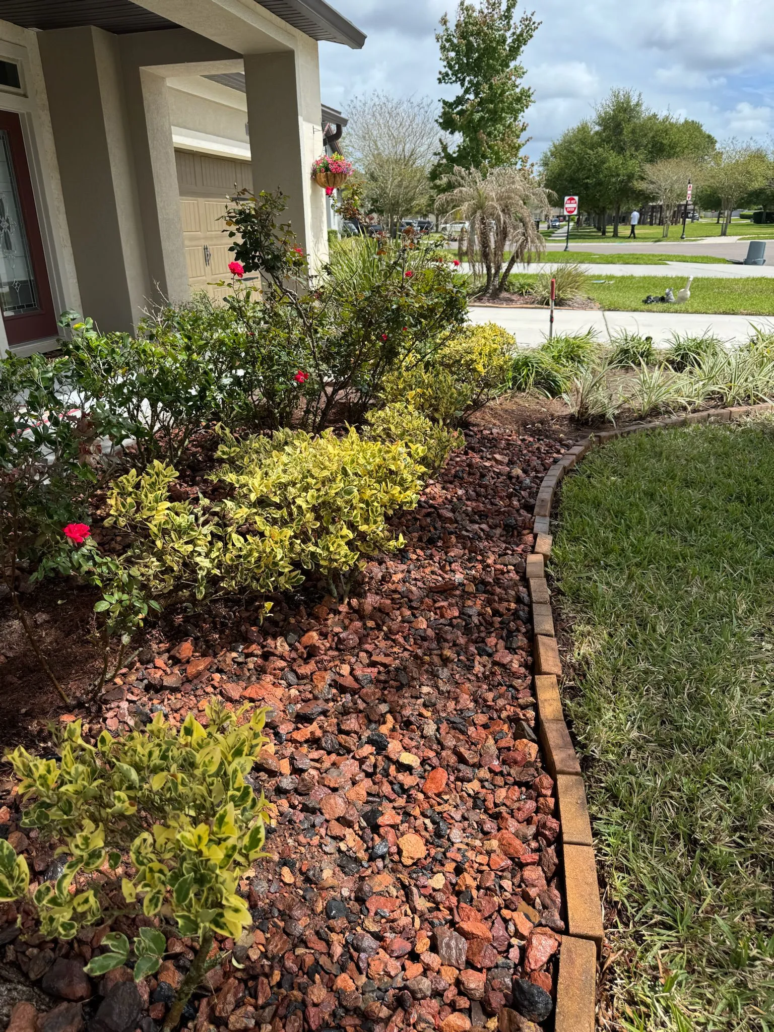 Red lava rock flower bed landscaping installation